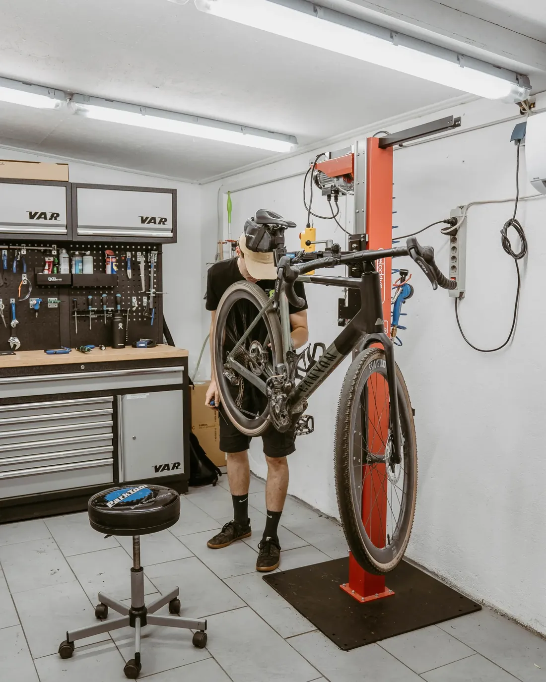 Mechaniker mit einem Rad im Montageständer